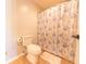 This bathroom includes a standard toilet and shower with a floral curtain at 3413 Putter Pl, Columbus, IN 47203