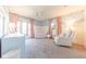 This cozy Bedroom features blue floral wallpaper, pink curtains, and a white crib for a cheerful atmosphere at 3413 Putter Pl, Columbus, IN 47203