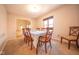 Bright dining room with table set for six, connecting to the living room at 3413 Putter Pl, Columbus, IN 47203