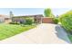 Charming home with a long driveway and a well-manicured lawn under a bright blue sky at 3413 Putter Pl, Columbus, IN 47203