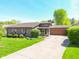 Charming single-story home with well-manicured lawn, landscaping and a spacious driveway at 3413 Putter Pl, Columbus, IN 47203