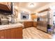 Well-appointed kitchen featuring stainless steel appliances, wood cabinets, and granite countertops at 3413 Putter Pl, Columbus, IN 47203
