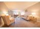Bright living room features neutral walls, carpet, and modern furniture arrangement with matching armchairs and sofa at 3413 Putter Pl, Columbus, IN 47203