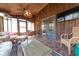 Cozy sunroom boasts wood walls, tile floors, and wicker furniture for relaxing at 3413 Putter Pl, Columbus, IN 47203