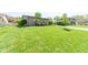 Expansive green lawn with mature trees offers plenty of space for outdoor activities at 3413 Putter Pl, Columbus, IN 47203