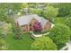 A beautiful brick home surrounded by lush landscaping and mature trees at 3790 Steeplechase Dr, Carmel, IN 46032