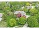 Stunning aerial view of a brick home with lush landscaping, mature trees, and a well-maintained lawn at 3790 Steeplechase Dr, Carmel, IN 46032