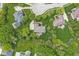 An aerial view of a property featuring mature trees, a well-manicured lawn, and surrounding homes at 3790 Steeplechase Dr, Carmel, IN 46032