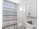 Modern bathroom with shower and tub combination, modern toilet, and well-placed vanity storage at 3790 Steeplechase Dr, Carmel, IN 46032