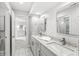 Spacious bathroom with double sink vanity, granite countertop, and walk-in access to bedroom at 3790 Steeplechase Dr, Carmel, IN 46032
