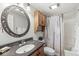 Cozy bathroom featuring a vanity with dark countertops and round mirror at 3790 Steeplechase Dr, Carmel, IN 46032
