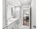 Bright bathroom featuring double sink vanity and entrance to bedroom and closet at 3790 Steeplechase Dr, Carmel, IN 46032