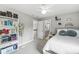 Cozy bedroom with a bookshelf, comfortable bed, and doorway to the bathroom at 3790 Steeplechase Dr, Carmel, IN 46032