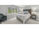 Cozy bedroom featuring a comfortable queen bed, side tables, and window allowing ample natural light at 3790 Steeplechase Dr, Carmel, IN 46032