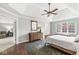 Comfortable bedroom with a tray ceiling, wooden furniture, and natural light from a large window at 3790 Steeplechase Dr, Carmel, IN 46032