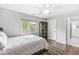 Well-lit bedroom with ceiling fan, a bookshelf and a large window with outside view at 3790 Steeplechase Dr, Carmel, IN 46032