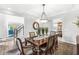 Bright dining room showcasing a wooden table, chandelier, and access to other living spaces at 3790 Steeplechase Dr, Carmel, IN 46032