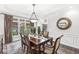 Formal dining room featuring a chandelier and large windows overlooking the front yard at 3790 Steeplechase Dr, Carmel, IN 46032