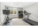 Cozy exercise room with a treadmill, stationary bike, TV, and a window for natural light at 3790 Steeplechase Dr, Carmel, IN 46032