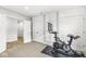 Exercise room featuring stationary bike, multiple doors for access, and neutral color scheme at 3790 Steeplechase Dr, Carmel, IN 46032