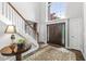 Grand foyer with a staircase, large window, and a beautiful wood front door, complemented by elegant decor at 3790 Steeplechase Dr, Carmel, IN 46032