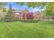 Charming brick home featuring mature trees, a well-maintained lawn, and tidy landscaping at 3790 Steeplechase Dr, Carmel, IN 46032
