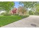 Charming brick home featuring lush landscaping, a driveway, and a well-manicured lawn under a bright blue sky at 3790 Steeplechase Dr, Carmel, IN 46032