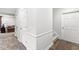 Bright hallway featuring tile flooring, white wainscoting, and neutral paint, leading to various rooms at 3790 Steeplechase Dr, Carmel, IN 46032