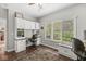 Bright home office with custom built-in cabinets, desk space, and a large window view at 3790 Steeplechase Dr, Carmel, IN 46032