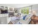 Bright and airy living room with a fireplace, built-in shelves, and large windows with green views at 3790 Steeplechase Dr, Carmel, IN 46032