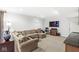 Comfortable living room featuring plush seating, a television, stylish decor, and neutral carpet at 3790 Steeplechase Dr, Carmel, IN 46032