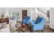 Comfortable living room featuring hardwood floors, blue armchairs, and bright, open spaces at 3790 Steeplechase Dr, Carmel, IN 46032