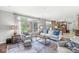 Inviting living room with a plush sofa, patterned rug, and large windows overlooking the greenery at 3790 Steeplechase Dr, Carmel, IN 46032