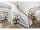 Elegant foyer featuring a staircase, hardwood floors, and views into adjacent living spaces at 3790 Steeplechase Dr, Carmel, IN 46032