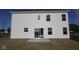 An exterior shot showcasing a backyard with a patio and sliding glass door at 3832 Highcrest Rd, Indianapolis, IN 46239