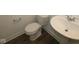Close-up of a white sink and toilet paired with wood-look flooring in a clean, modern bathroom at 3832 Highcrest Rd, Indianapolis, IN 46239