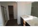 Bright bathroom with dark cabinets, double sinks, white countertops, and a glass shower door at 3832 Highcrest Rd, Indianapolis, IN 46239