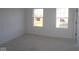 Bright, unfinished bedroom with two windows offering natural light, ready for your personal design at 3832 Highcrest Rd, Indianapolis, IN 46239