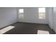 Bright bedroom with neutral carpet, white trim, and two windows offering plenty of natural light at 3832 Highcrest Rd, Indianapolis, IN 46239