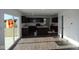 This open kitchen features dark wood cabinets, white countertops, an island, and stainless steel appliances at 3832 Highcrest Rd, Indianapolis, IN 46239