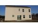 New two-story home featuring a sliding glass door leading to a backyard, perfect for outdoor activities at 3832 Highcrest Rd, Indianapolis, IN 46239