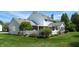 View of the white home's backyard with a covered patio and a white picket fence at 4243 Bay Leaf Cir, Indianapolis, IN 46237