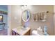 Half bathroom featuring a toilet, mirror, and wash basin at 4243 Bay Leaf Cir, Indianapolis, IN 46237