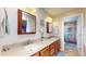 Bathroom featuring double sinks, wood cabinets, a tile floor, and a walk-in shower at 4243 Bay Leaf Cir, Indianapolis, IN 46237