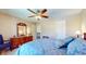 Comfortable bedroom with ceiling fan, large dresser, and decoratively patterned bedding at 4243 Bay Leaf Cir, Indianapolis, IN 46237