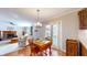 Open dining area featuring a chandelier, hardwood floors, and easy access to the kitchen and living room at 4243 Bay Leaf Cir, Indianapolis, IN 46237