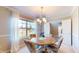 Bright dining room featuring a window, a light fixture, and a classic wooden table with chairs at 4243 Bay Leaf Cir, Indianapolis, IN 46237