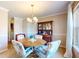 Cozy dining room with a wooden table set, soft carpet, and traditional decor with a hutch at 4243 Bay Leaf Cir, Indianapolis, IN 46237