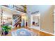 Elegant foyer with high ceilings, hardwood floors, staircase, and decorative details at 4243 Bay Leaf Cir, Indianapolis, IN 46237