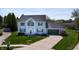 Inviting two-story home featuring a well-maintained lawn, mature trees, and a two-car garage at 4243 Bay Leaf Cir, Indianapolis, IN 46237
